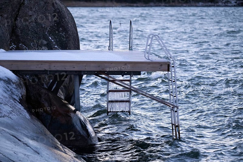 Jetty on a wintry coast with waves and icicles on a staircase, Korpoström, Korpo or Korppo, southwestern archipelago, Finland