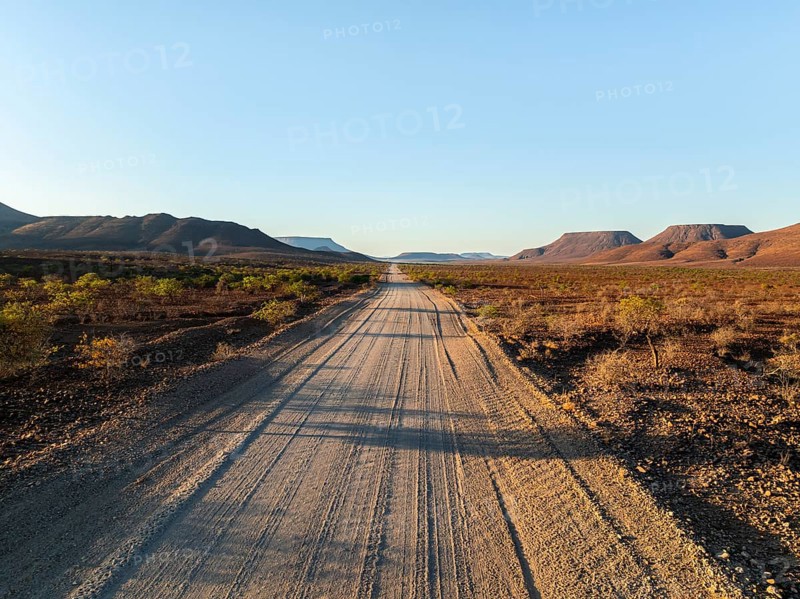 Beautiful dirt road through dry desert landscape, hills in Damaraland, Namibia