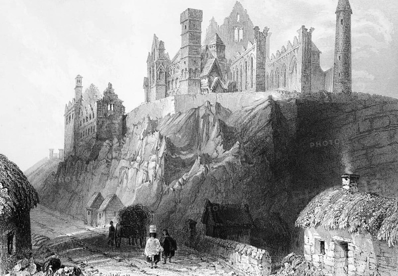 Gothic cathedral ruin on the Rock of Cashel, County Tipperary, Ireland, street, people, cottages, smoking chimney, horse-drawn carriage, hill, rock, nave, religion, round tower, shelter, landmark, steel engraving, 19th century, historical illustration from 1845