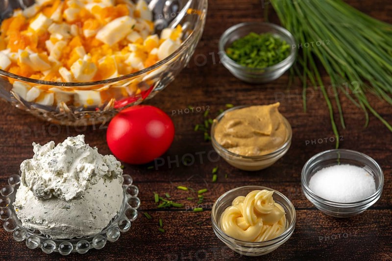 Eggs, cream cheese and spices for a spread in bowls