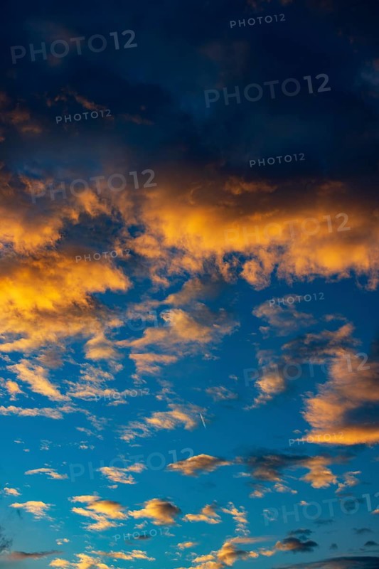 Aircraft contrails with red clouds, sunrise, Upper Austria