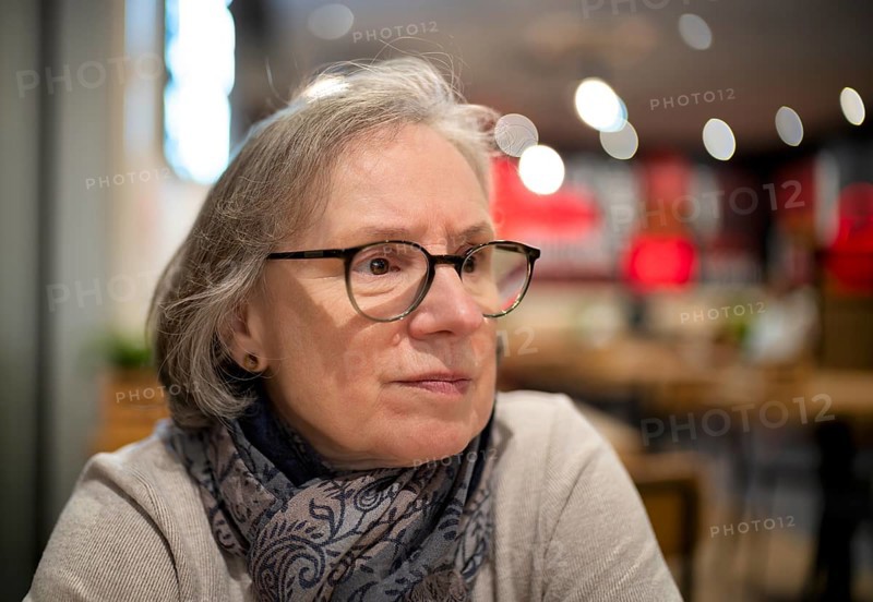 Elderly woman, portrait, glasses, gray hair, scarf, sitting in a bar, restaurant, Stuttgart, Baden-Württemberg, Germany