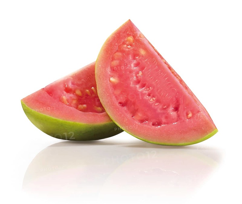 Two quarters of a sliced guava (Psidium guajava) in front of a white background, studio photo