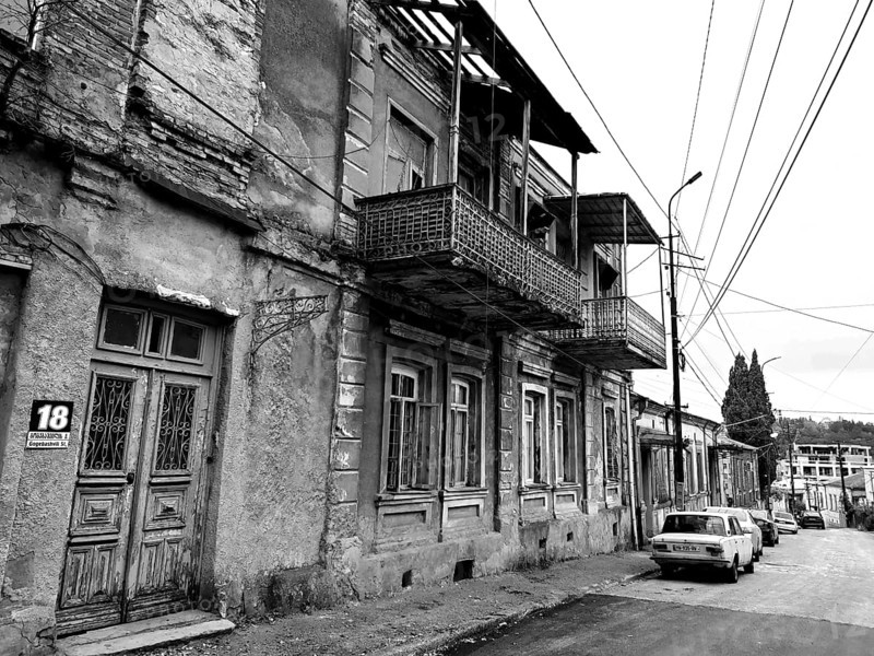 Deserted street with old, dilapidated buildings and a nostalgic parked classic car, car, monochrome, Georgia