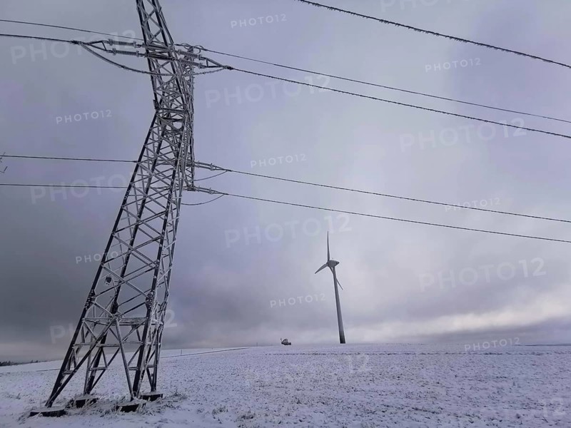 View of a wind turbine and a power pole in a snowy winter landscape, Rennsteig, Frankenwald nature park Park