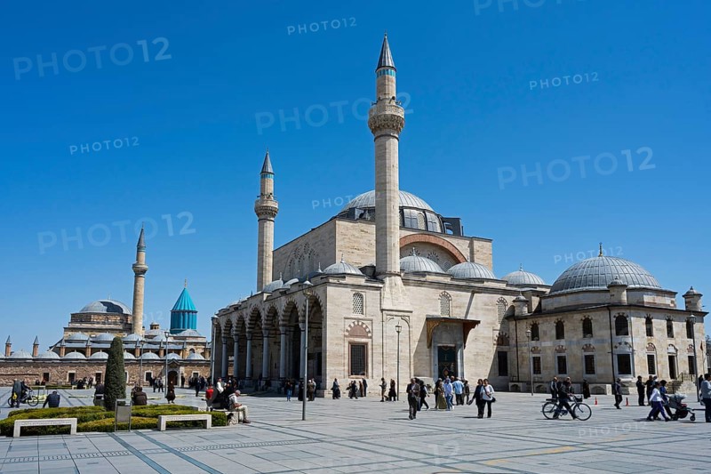 Historic mosque with several minarets under clear blue sky, people gathered in the square, Mevlânâ Museum, Mevlana, landmark, mausoleum of Mevlânâ Jalal ad-Din Rumi, Konya Sultan Selim Camii, Konya, Central Anatolia, Turkey