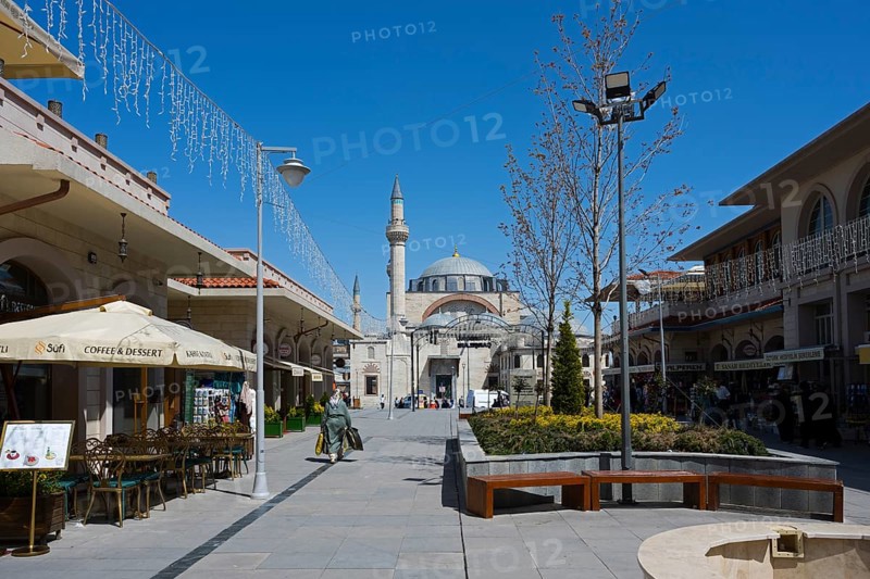Wide pedestrian zone with shops and street cafés, a mosque in the background under a blue sky, mosque, Konya Sultan Selim Camii, Konya, Central Anatolia, Turkey