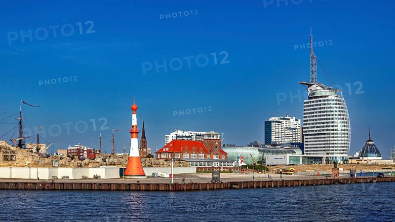 Lighthouse and modern buildings at the harbor under clear skies, The City of Bremen