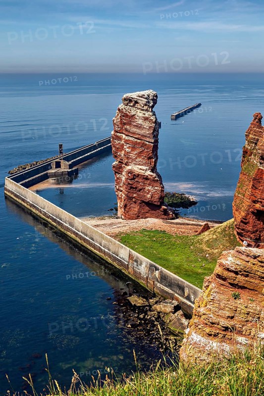 High rock by the sea with a protective wall, the high-seas island of Heligoland in the North Sea