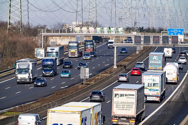 A57 motorway near Kaarst in the Rhein-Kreis Neuss, view towards Kaarst motorway junction, heavy traffic, overhead line, high-voltage lines, along the motorway, North Rhine-Westphalia, Germany
