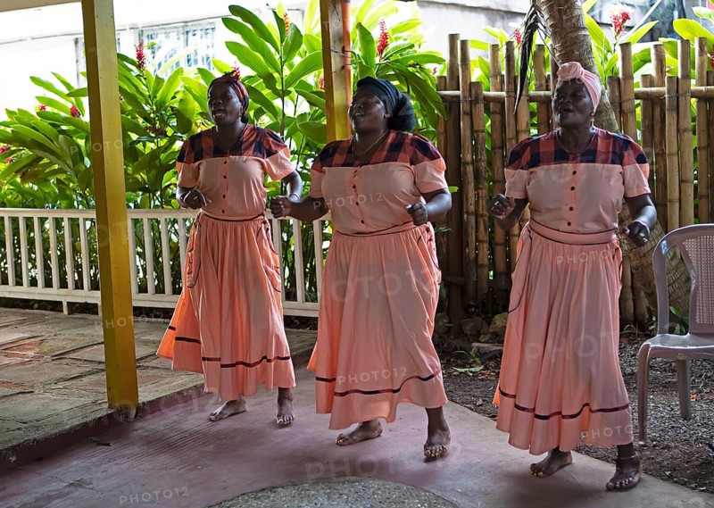 Guatemalan woman in traditional clothing singing and dancing, Garifuna people, Livingston, Izabal Department, Guatemala