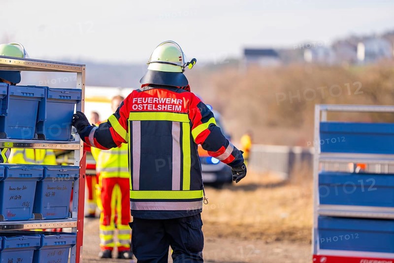 A firefighter in uniformed clothing stands on a railway line with equipment, fire department practice at the Hermann Hesse Railway, Ostelsheim, Calw district, Germany