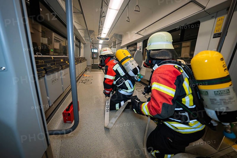 Two firefighters are working on a safety incident inside a train, fire brigade exercise on the Hermann Hesse Railway, Ostelsheim, Germany