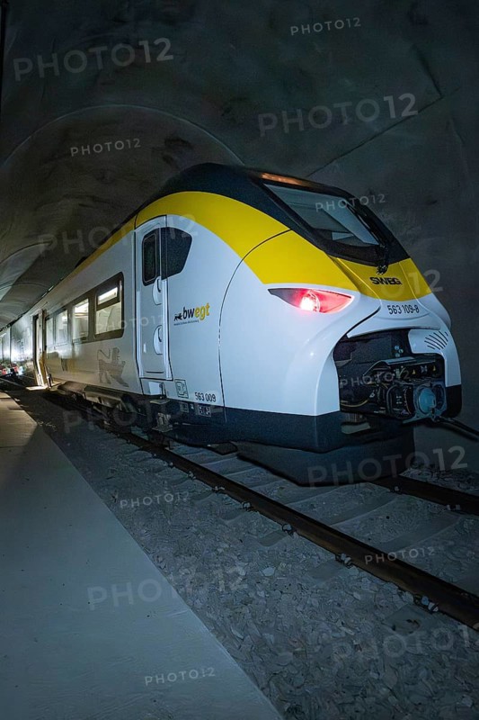 A train with yellow and white colors stands in the tunnel at night, fire department exercise on the Hermann Hesse Railway, Ostelsheim, Germany