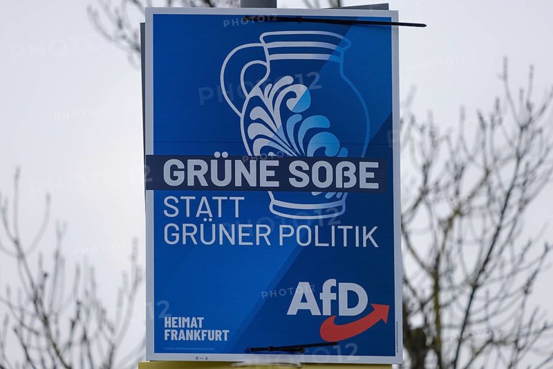 An Alternative for Germany (AfD) election poster with the slogan Green sauce instead of green politics hangs on a lamp post in Frankfurt am Main. The Hessian state government has set 15 March 2026 as the election date for local elections in Hesse. On this day, the elections for the city council and the 16 local councils will take place in Frankfurt, Frankfurt am Main, Hesse, Germany