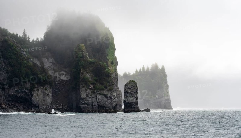 Mystical fog sweeps around rocky islands on the coast, Kenai Fjords National Park, Kenai Peninsula, Alaska, USA