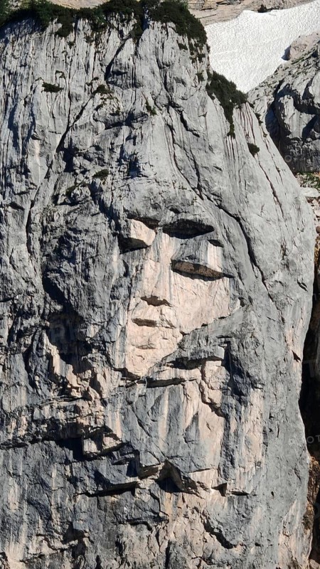Natural formation of a face in a rock wall, Slovenia