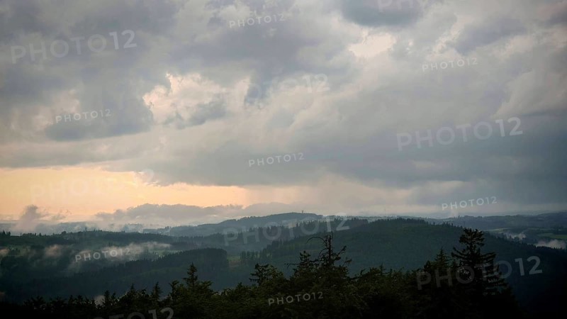 Dense clouds cover the mountain landscape and create an oppressive atmosphere, Fichtelgebirge