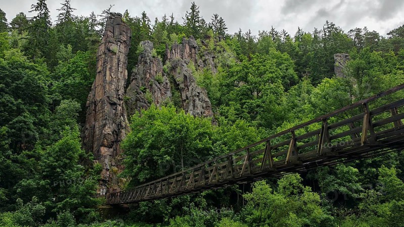 Suspension bridge leads across a river through wooded rocks, Hans Heiling Rocks, Eger Valley, Czech Republic