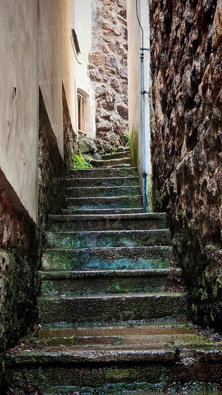 Weathered stone staircase in a narrow alley with historic walls, Loket, Czech Republic
