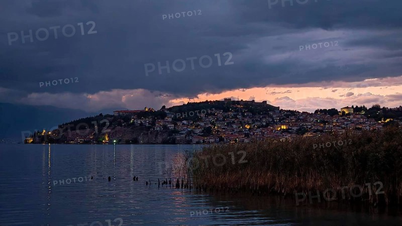 Night scene of an illuminated lake with a city in the background, Lake Ohrid, North Macedonia