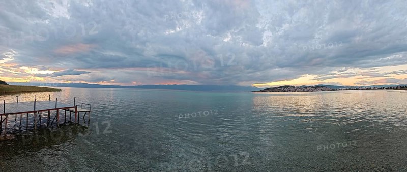 Panoramic view of a lake at sunset, with a jetty in the foreground, Lake Ohrid, North Macedonia