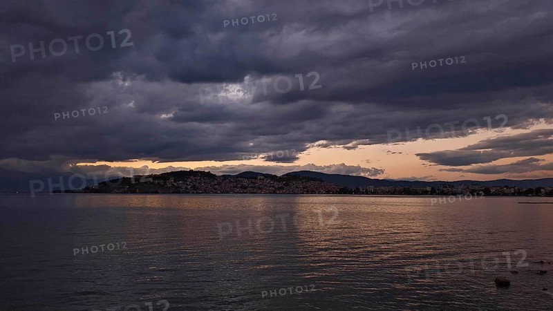 View of a lake at sunset with dramatic clouds covering the sky, Lake Ohrid, North Macedonia