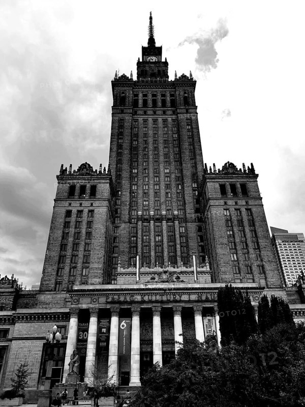 Majestic skyscraper Palace of Culture in historical style in black and white under cloudy sky, Warsaw, Poland