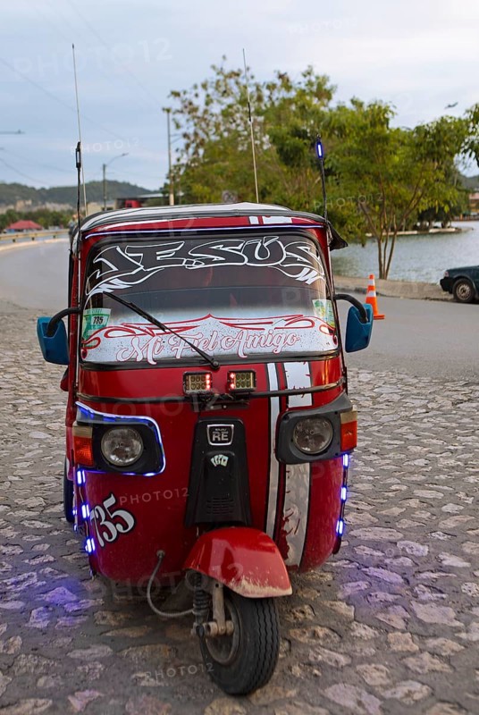 Red tuk tuk or tricycle taxi in Flores, Petén Department, Guatemala