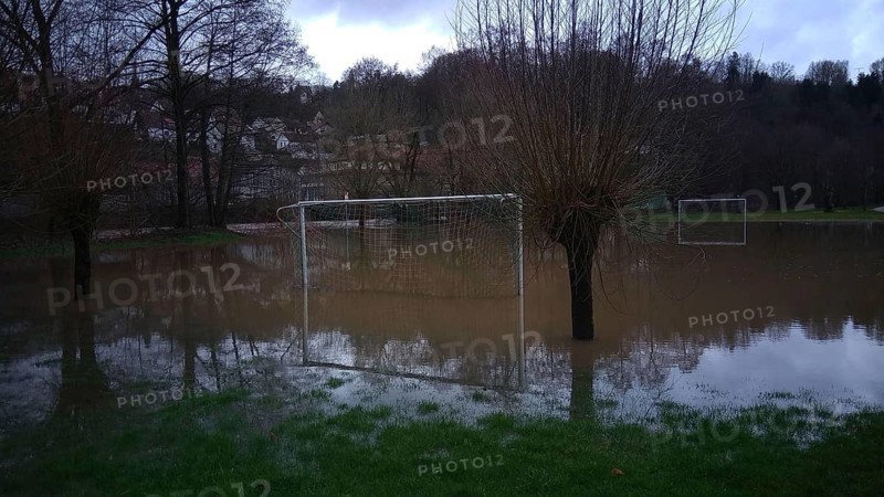 Football field is under water, surrounded by trees, snow melt high water, Kronach, Upper Franconia
