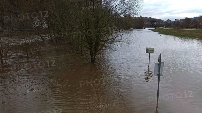 Flooded landscape with half-submerged trees and cloudy water, winter floods after snowmelt, Kronach, Upper Franconia