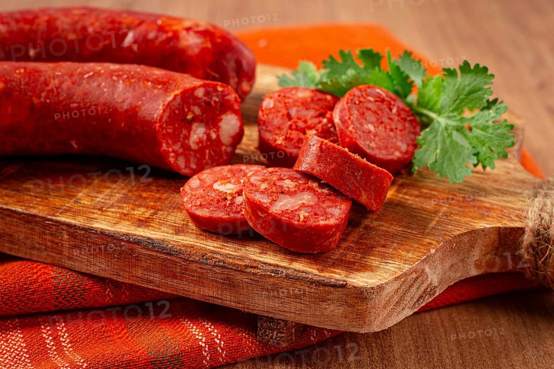 Spicy Chorizo sausage, on a cutting board, on a wooden table