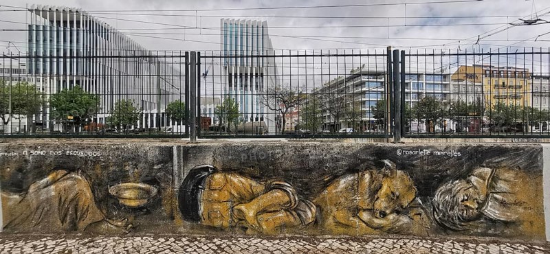 Street art depicts homeless people against a modern urban backdrop, Lisbon, Portugal
