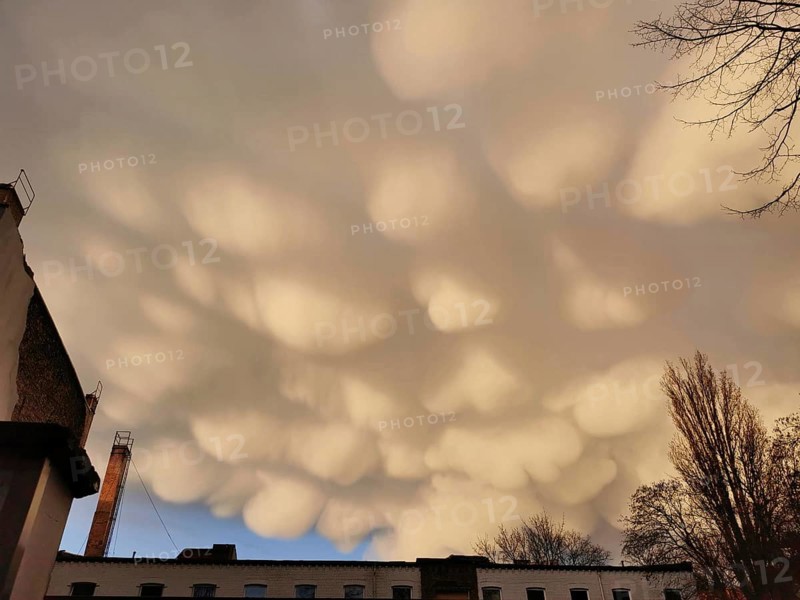 Impressive mammatus clouds float over urban landscape at sunset, Pankow, Berlin, Germany