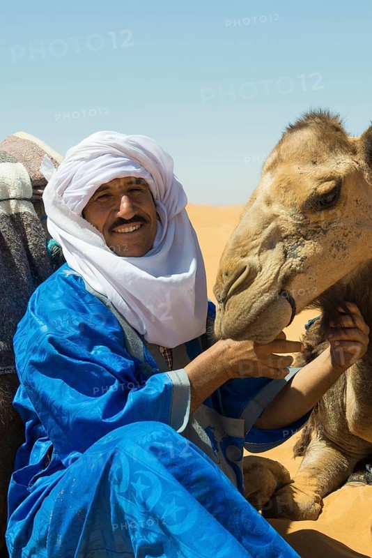 Berbers and dromedaries in the sand dunes, near Merzouga, Meknès-Tafilalet region, Erg Chebbi, northern Sahara, Morocco
