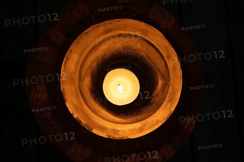 Ice bowl illuminated by a burning tea light, winter, Finland