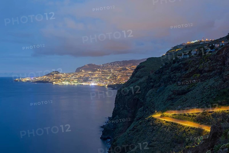 View of the Atlantic Ocean from Christo Rei viewpoint at dusk, harbour with cruise ships and Funchal, Madeira, Portugal