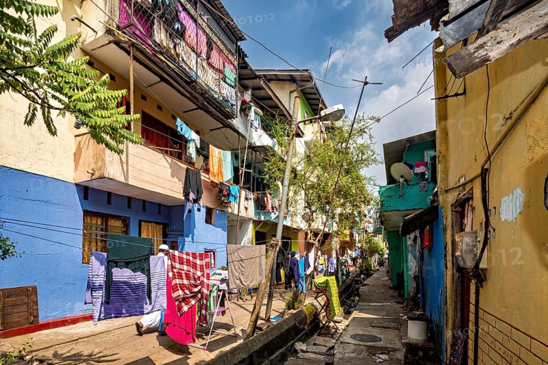 Colourful narrow neighborhood alleyway with clotheslines and a homely atmosphere