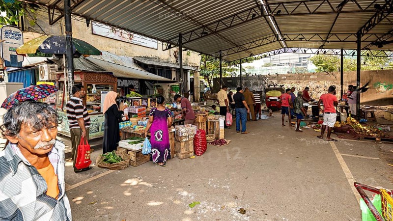 Busy street market with market stalls and people under one roof in an urban environment