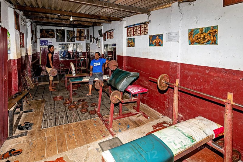 Classic gym with dumbbells and artwork on the wall, rustic ambiance