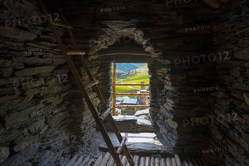 Stone interior of a defence tower with ladder and view of a green valley, in the tower of Queen Tamar, Tamara, defensive tower, Ushguli, district of Chazashi, Chazhashi, Mingrelia and Upper Svaneti region, Svaneti, Georgia