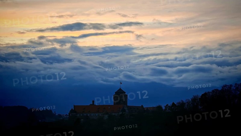 Castle silhouette against dramatic sunset sky, calm and mystical atmosphere, Rosenberg Fortress, Franconian Forest