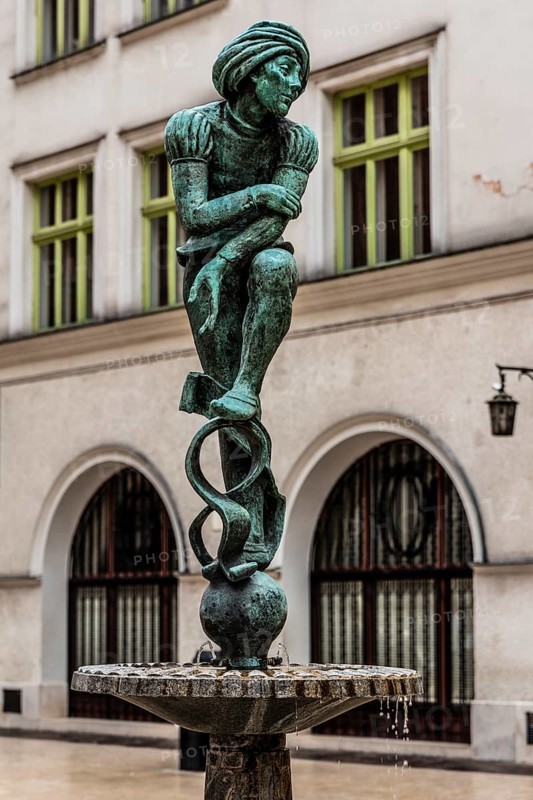 Fountain with student statue in historic clothing, Krakow, Poland