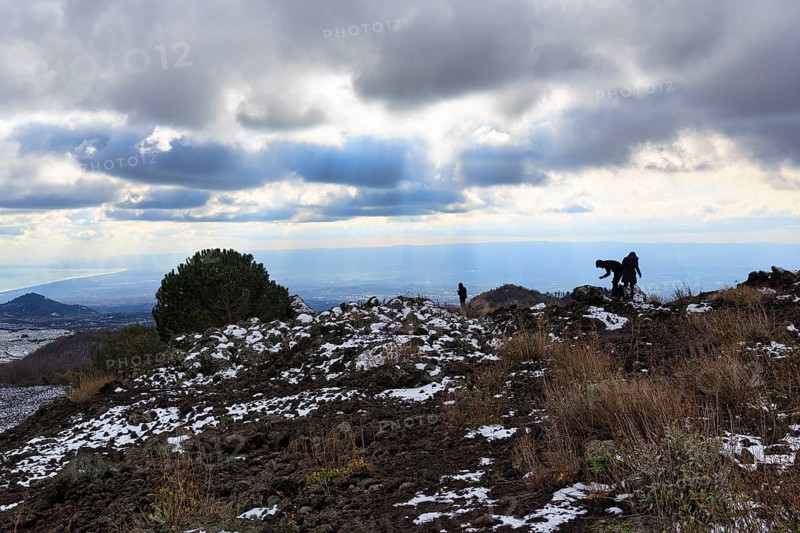 Barren volcanic landscape with remnants of snow, hikers, Etna, Etna, Catania, Sicily, Italy