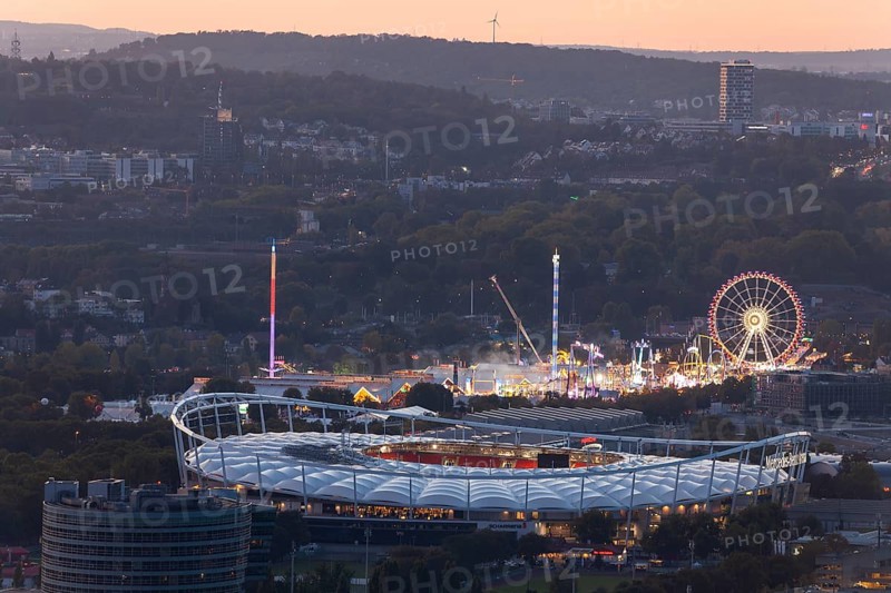 29 Sep 2018 at dusk, Volksfest lights seen from Rotenberg chapel with stadium foreground and Pragsattel background. Stuttgart, Baden-Wurttemberg, Germany