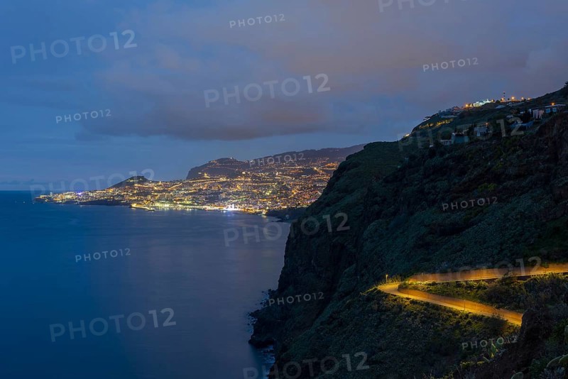 View of the Atlantic Ocean from Christo Rei viewpoint at dusk, harbour with cruise ships and Funchal, Madeira, Portugal