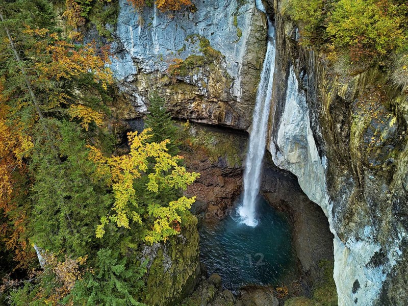 Aerial view of Berglistüber waterfall in autumn-colored surroundings, Linthal, Klausenpass, Canton of Glarus, Switzerland