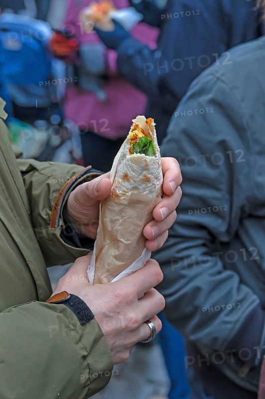 Hands holding a fresh falafel with vegetables, Nuremberg, Middle Franconia, Bavaria, Germany