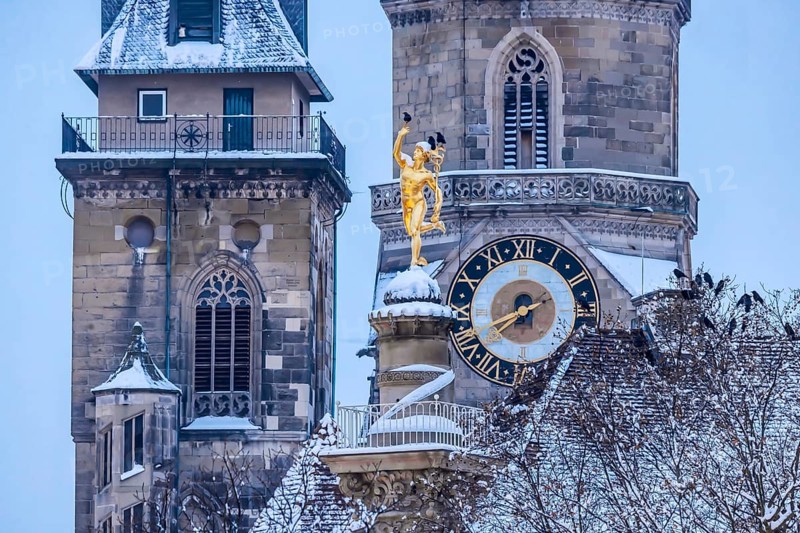 Winter in Stuttgart. The city is wintry white early in the morning. Collegiate church with Mercury's Column. Stuttgart, Baden-Württemberg, Germany