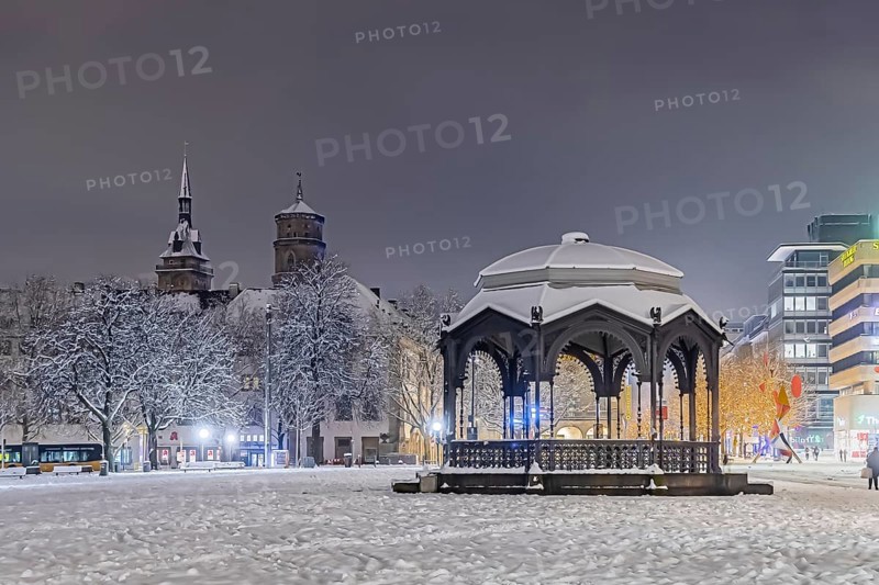 Winter in Stuttgart. The city is wintry white early in the morning. Palace Square with bandstand and collegiate church. Stuttgart, Baden-Württemberg, Germany